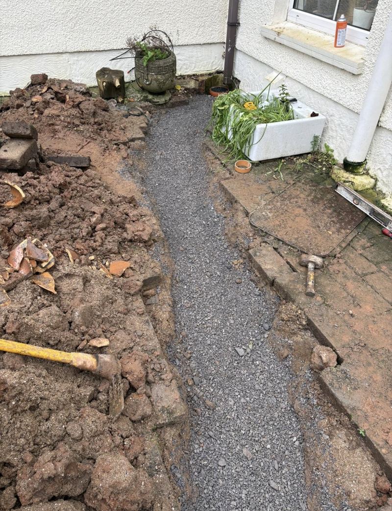 Trench backfilled with gravel and reinstated